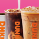 Coconut milk pouring into Dunkin' coffee on pink and yellow background
